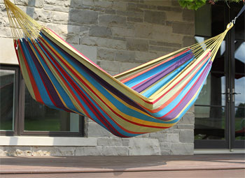 Striped Brazilian Style Hammock Hanging Outside on Patio