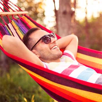 Man Sleeping in an Ecuadorian Hammock Outside