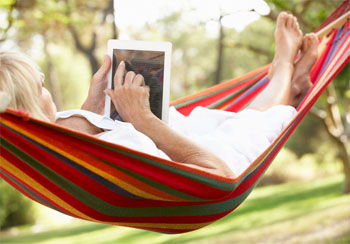 Woman Working on Tablet in Hammock